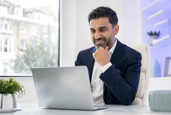 A London business owner reviewing how their business appears across AI answers, Google and Maps on a laptop.